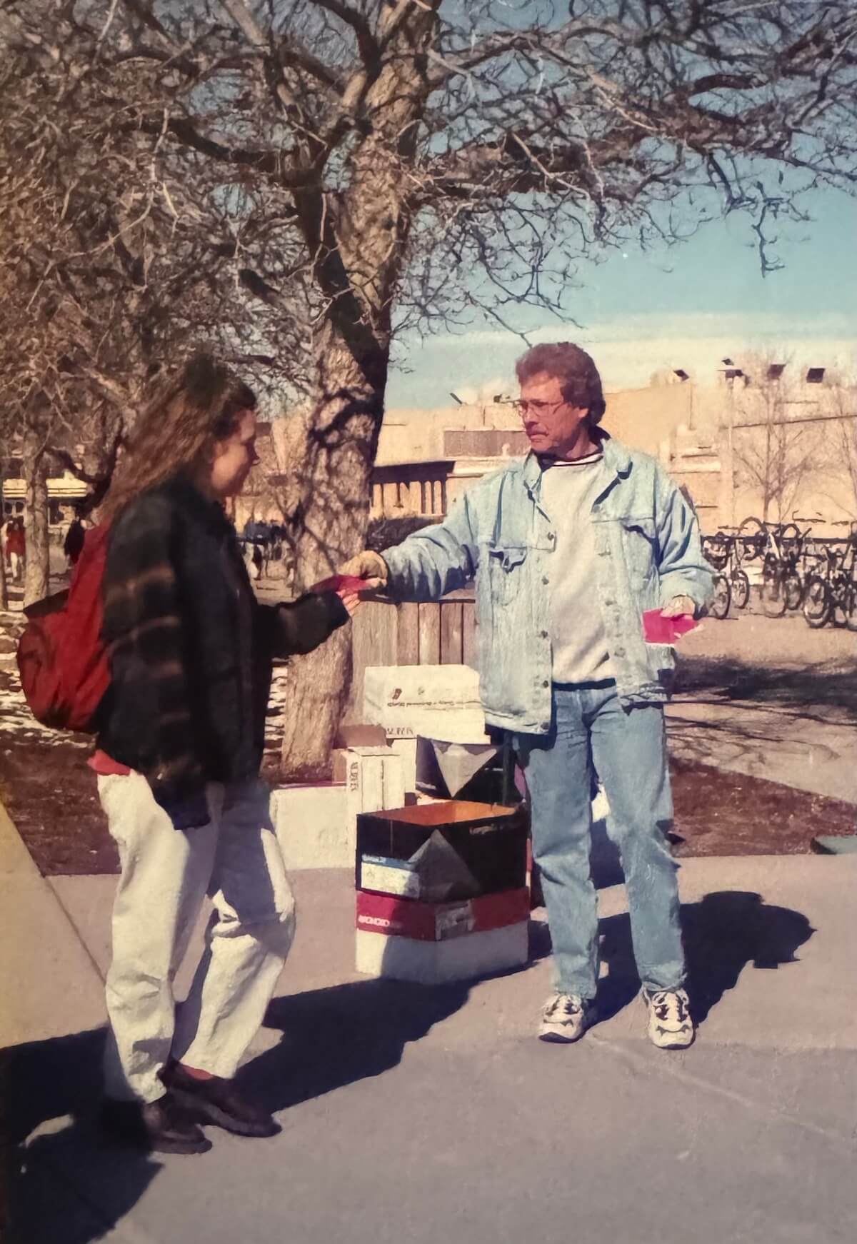 IMG_1233 copy man handing out coupon books on a college campus